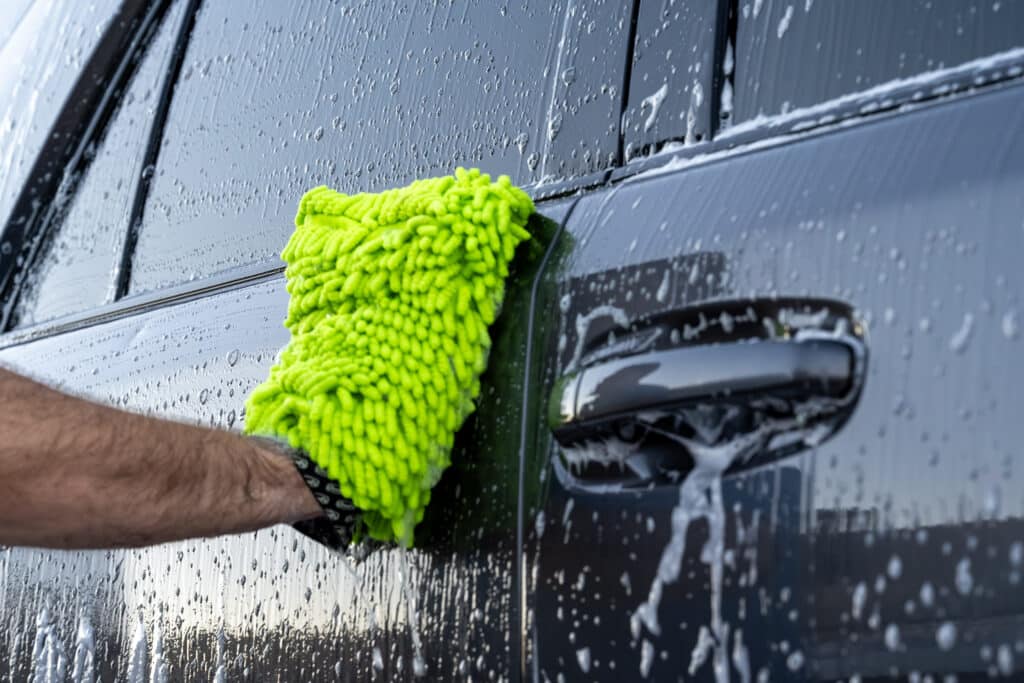 Hand washing SUV with microfiber mitt during mobile auto detailing in Scottsdale AZ